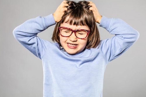 A girl pulling her own hair.