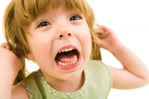 A girl pulling her hair representing trichotillomania in children.