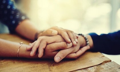 Two hands touching each other.