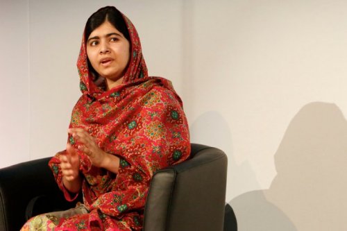Malala Yousafzai sitting on a chair.