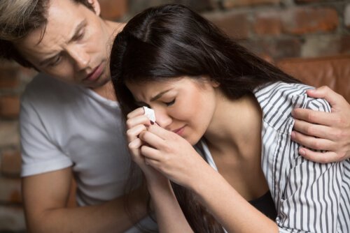 A man consoling his coworker.