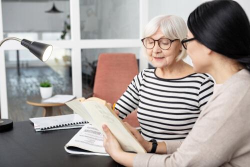 An older woman talking to a young psychologist in her office.