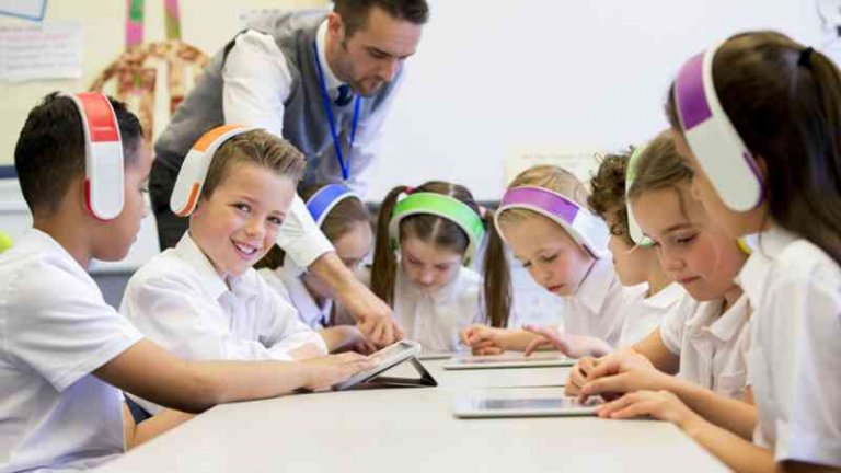 A teacher showing students new technology.