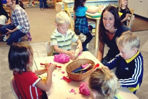 A teacher working with kids in the classroom.