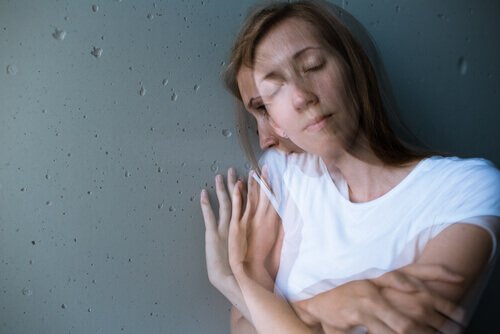 A woman leaning up against a wall with split personality.