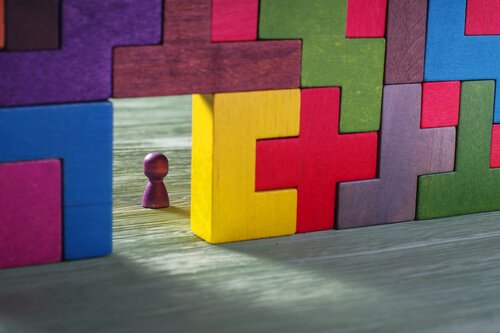 A picture showing wooden Tetris blocks stacked up with a gap by the floor.