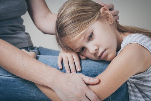 A woman consoling a girl.