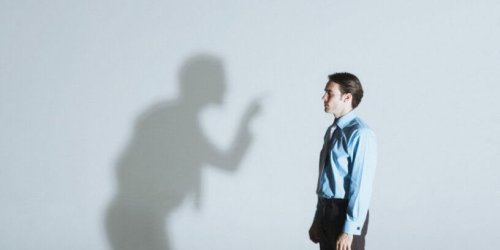 A businessman being scolded by a shadow.