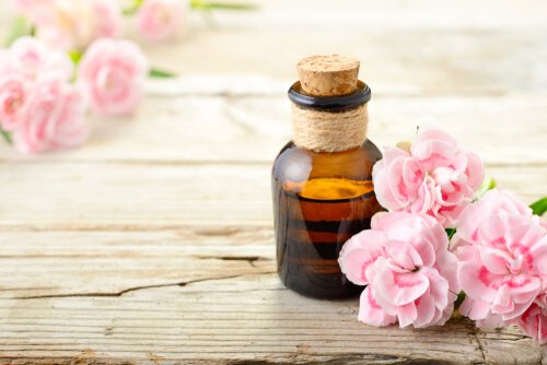 aromatherapy and a bottle of an aroma surrounded by flowers