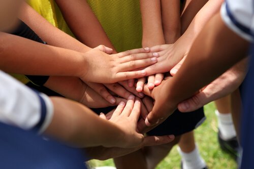 A photo of a group of hands touching.