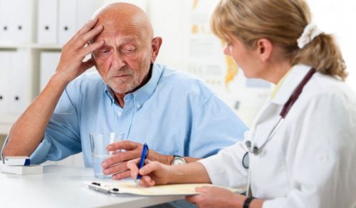 An elderly man with dementia talking to his doctor.