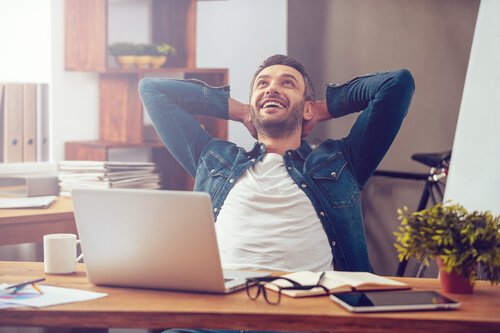 a man sitting happily at a desk