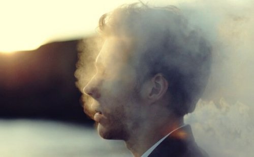 man surrounded by smoke