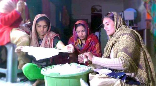 Women in India making sanitary towels.