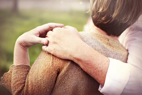 an old couple hugging