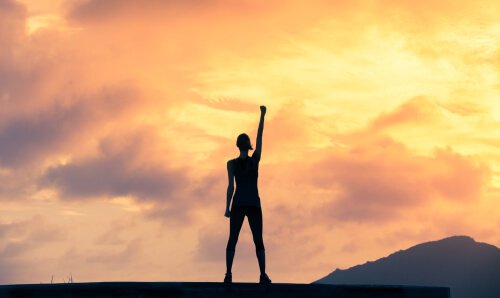a person lifting their arm in triumph