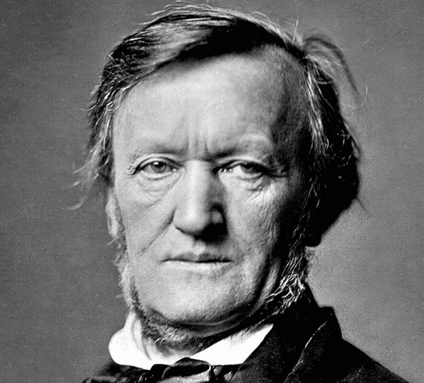 A black and white photo, showing Richard Wagner in middle-age, from the neck up, looking straight at the camera. 