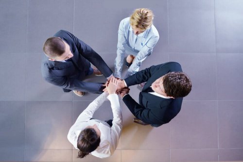 team doing a group handshake