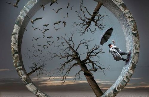 wheel with trees, a man, and an umbrella inside