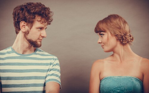 A woman and a man looking at each other.