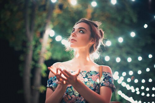 A woman surrounded by lights.