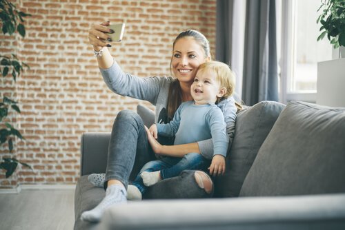 a woman taking a selfie with her baby boy