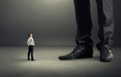 A tiny man looking up at a gigantic man.
