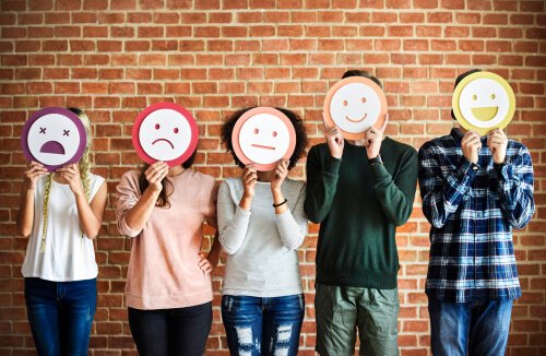 Five people with emoticon masks.