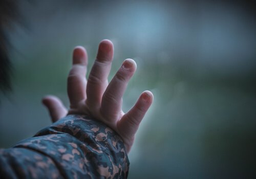 A boy's hand on the window pane.
