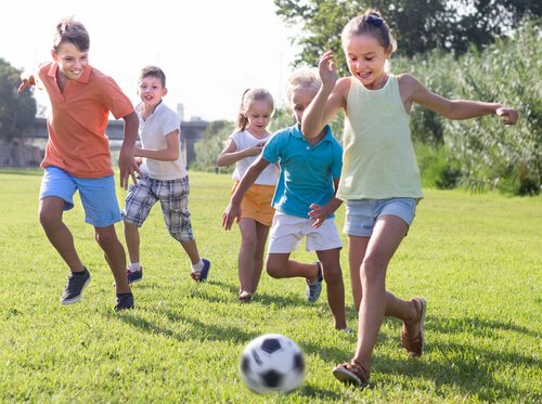Children playing soccer together.