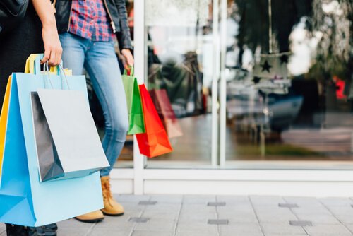 woman holding many shopping bags