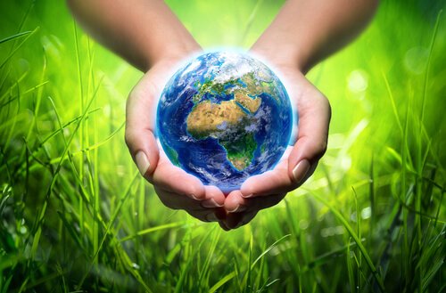 A hand holding the Earth.