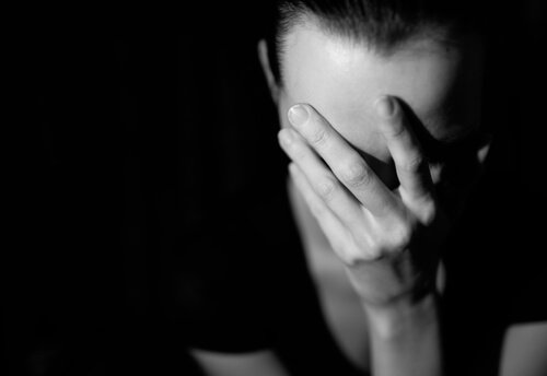A woman with a headache.