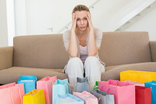A woman feeling worried after realizing she's been a victim of the Diderot effect.