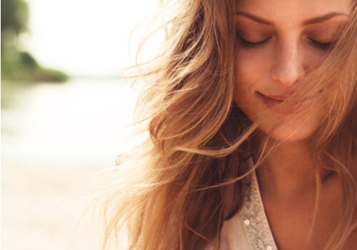 A happy woman looking down.