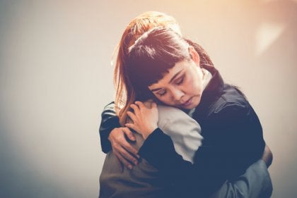 Two friends hugging each other.