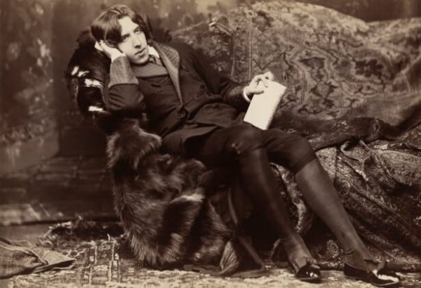 Oscar Wilde's photo of relaxing on a sofa.