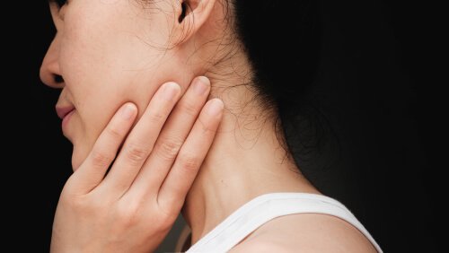 A woman holding her neck.