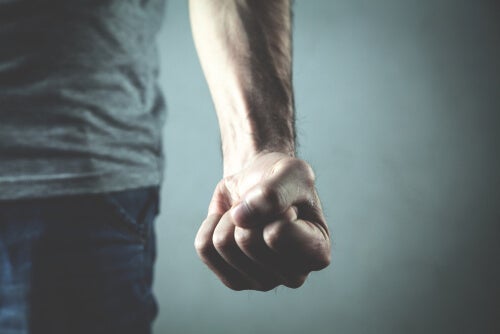 A man with a tight fist about to commit an act of human violence.