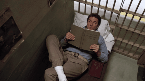 Frank Morris lying on a prison bed.