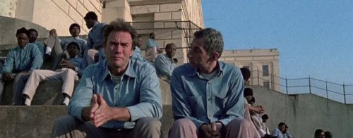 Frank Morris seated in a patio with many other men.