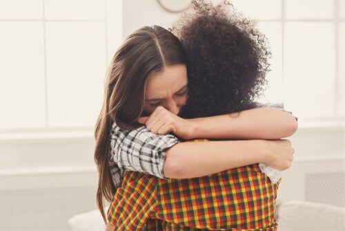 Two people hugging each other.
