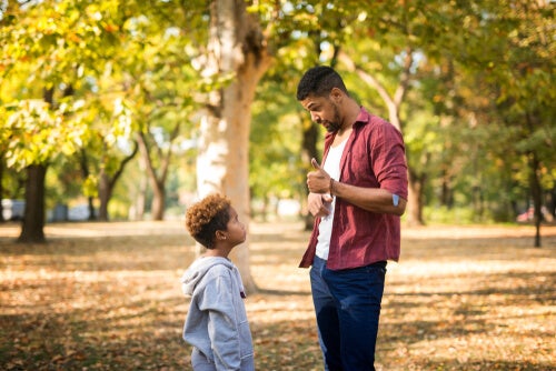 A father having a stern talk with his son.