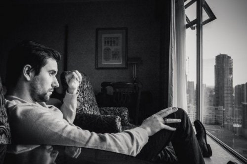A man with malignant narcissism looking out the window.