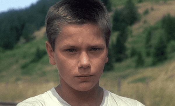 A photo of the actor looking at the camera in the movie Stand by Me.