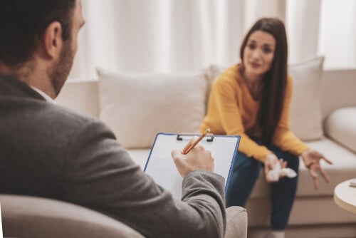 A woman facing her therapist during a session.