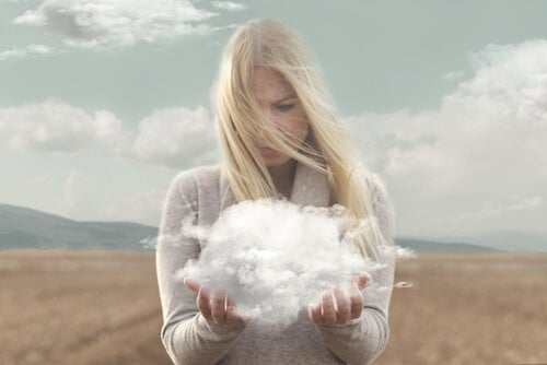 A woman holding a cloud in her hands.