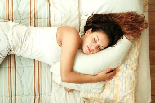 A woman sleeping on a bed.