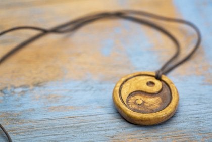A yin and yang pendent necklace.