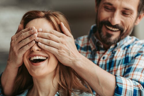 A man surprising a woman.